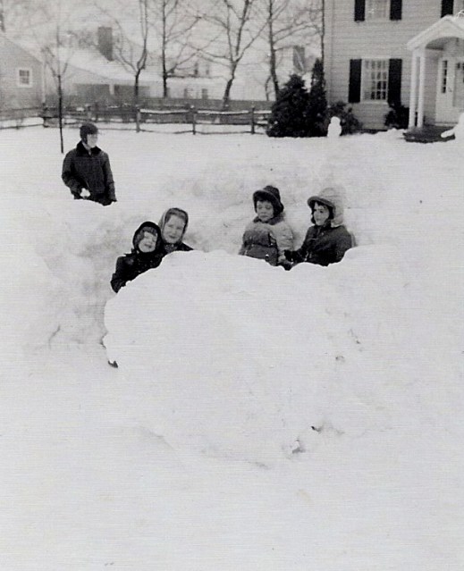 Outside our igloo with my brother (standing) and two neighborhood children.  I'm on the left of my mother.